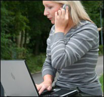 Woman on laptop, phone (iStock)