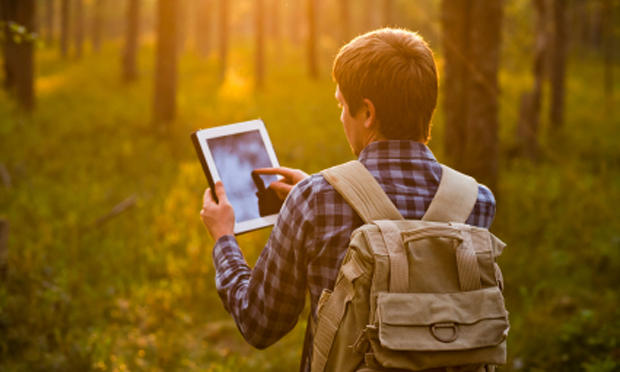 hiker with computer tablet (iStock)
