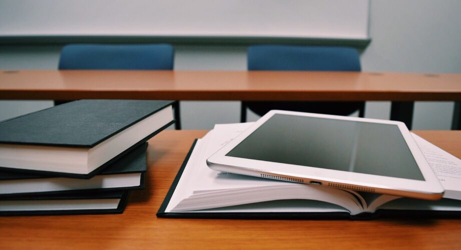 Books and tablet on a classroom desk