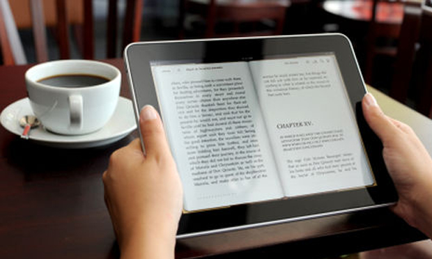 Reading iPad at breakfast (iStock)