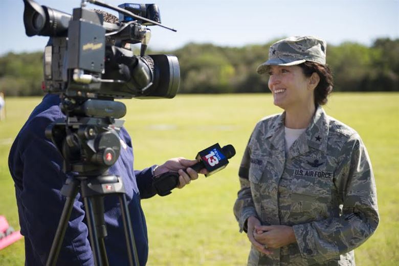 Woman being interviewed by TV reporter