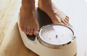 Person measuring weight on scale - Journalist's Resource