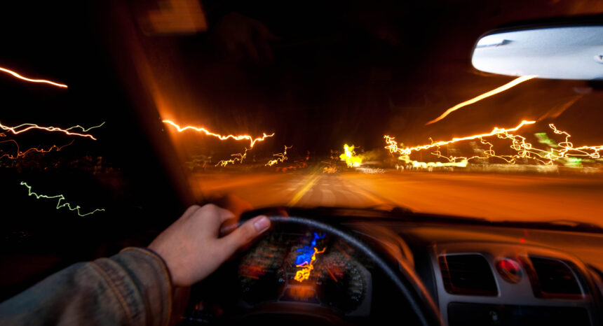 Person driving car at night