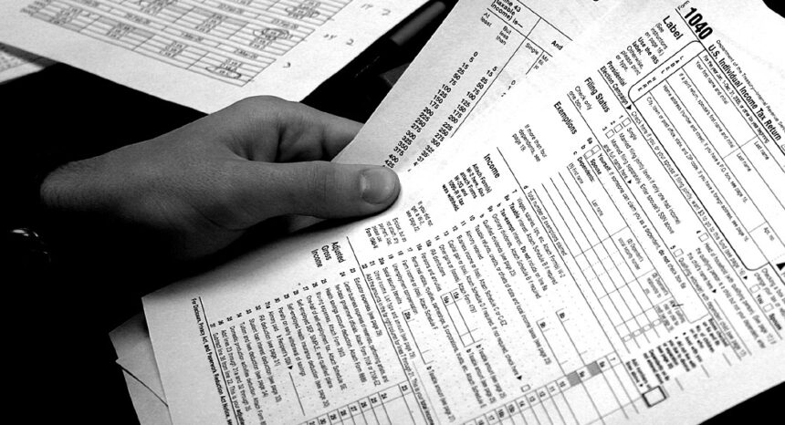 Person holding federal tax return forms