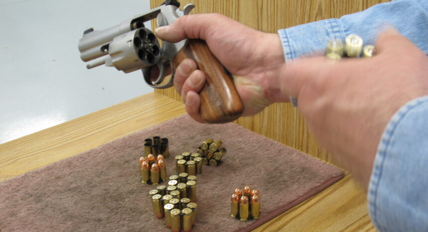 Man examining revolver