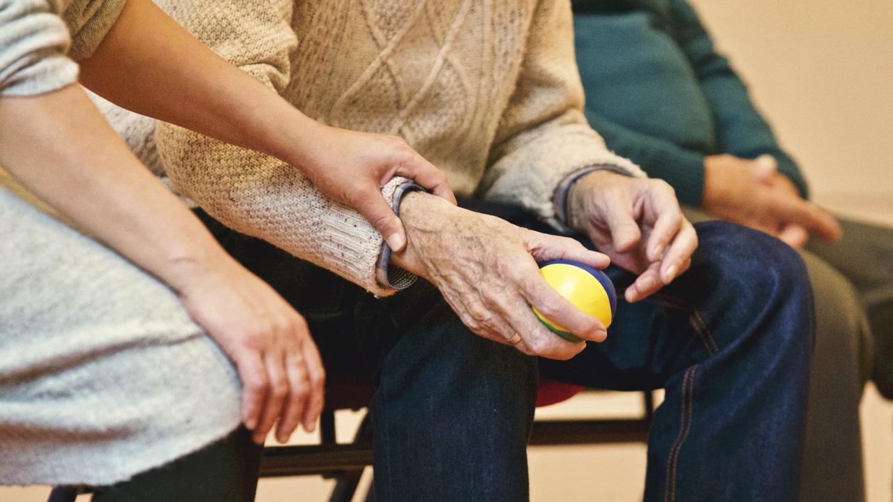 elderly person holding ball