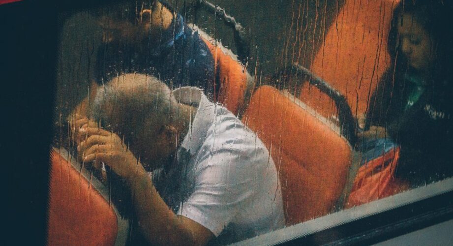man on bus in rain