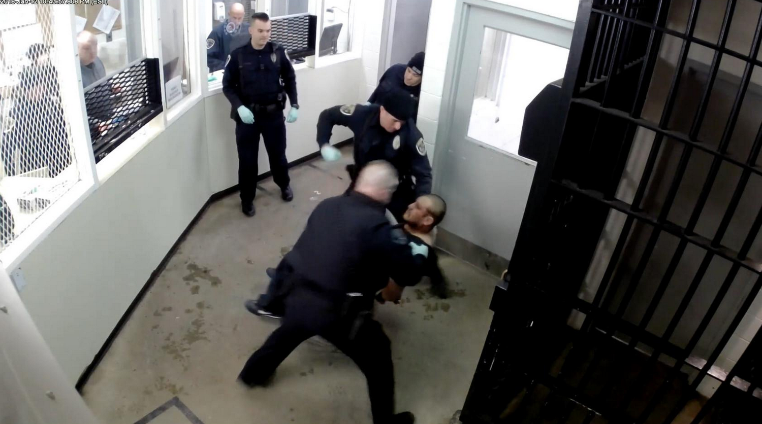 Screenshot of video showing police hitting handcuffed man