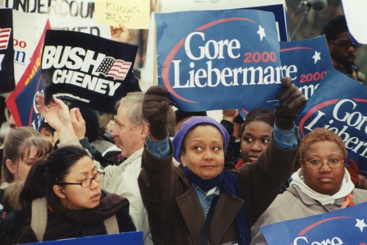 Bush and Gore supporters hold signs in 2000.