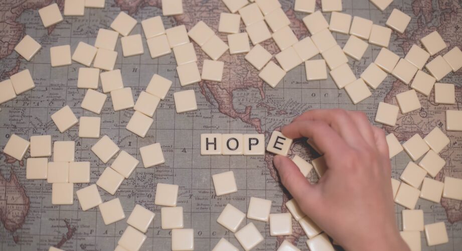 scrabble spelling of hope on a world map