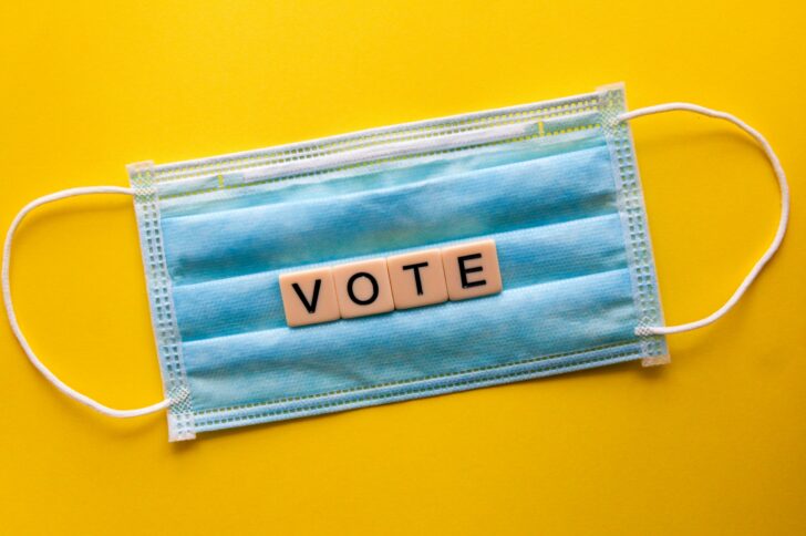 The word VOTE spelled out on a blue surgical mask