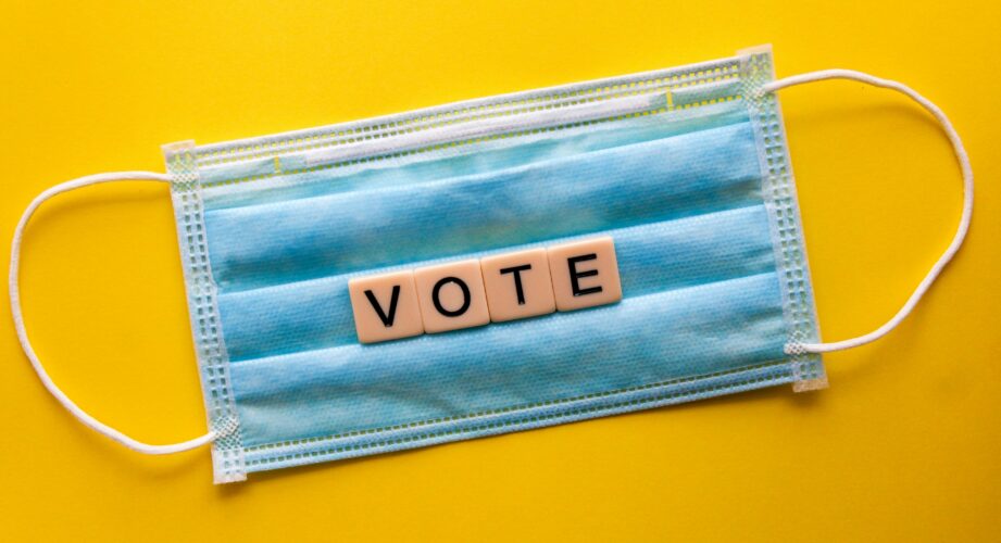 The word VOTE spelled out on a blue surgical mask