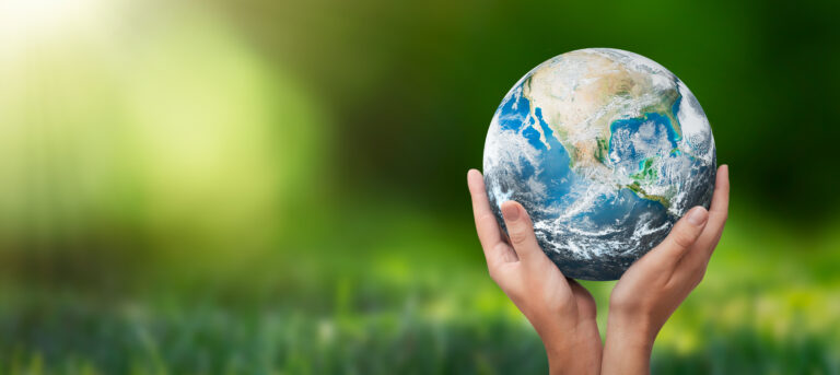 Hands raised to Earth globe.