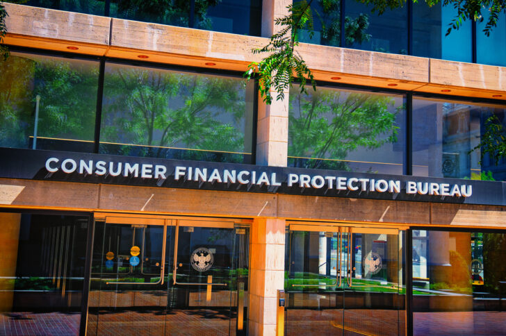 Exterior of the Consumer Financial Protection Bureau building with large glass windows and a sign reading ‘Consumer Financial Protection Bureau’ above the main entrance.
